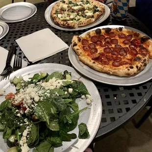 Greek salad, pepperoni pizza, artichoke and bacon pizza