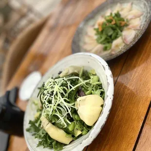 Big green salad bowl with avocado and garlic dressing