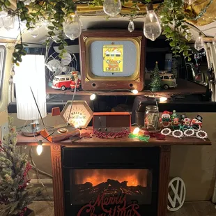 Warm your feet by the fire while creating amazing memories inside this artfully decorated photobooth &quot;living room&quot; on wheels!