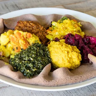 Healthy and delicious vegan deluxe combo , on injera/ gluten free flat bread/