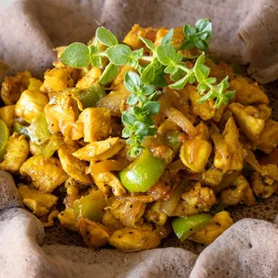 Healthy stir fried chicken with vegetables with gluten free teff injera / flat bread/