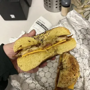 a hand holding a sandwich