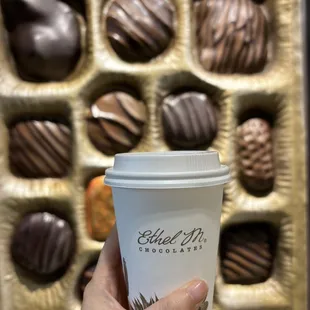 a hand holding a cup of coffee