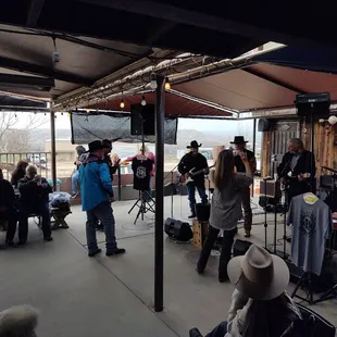 a group of people standing under a tent