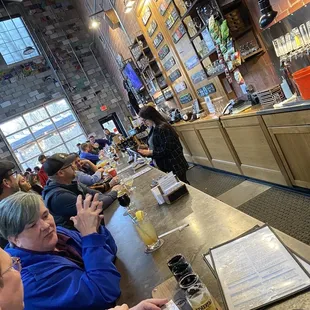 a group of people sitting at a bar