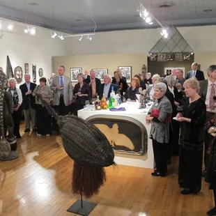 Crowd shot at a gallery opening.