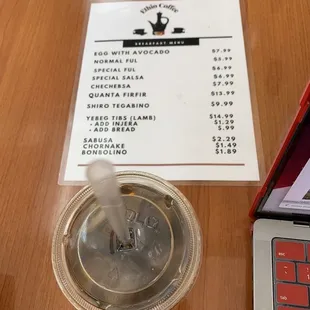 a cup of coffee and a menu
