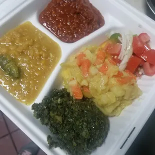 a variety of food in a styrofoam container