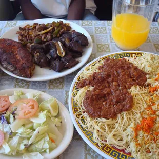 fish, goat, beef, and salad served with spaghetti and rice... a lot of delicious food!
