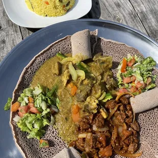 Veggie rice , beef tibs and goat akikl, injera flat bread and Ethiopian salad