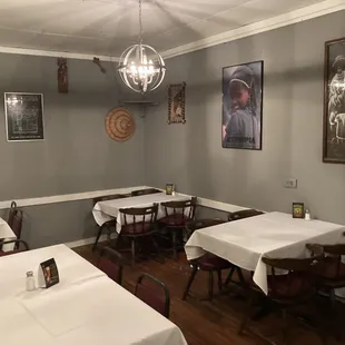 tables and chairs with white tablecloths