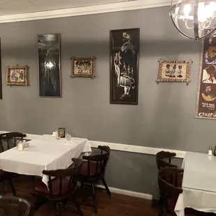 tables and chairs with white tablecloths