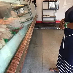a woman standing in front of a display case