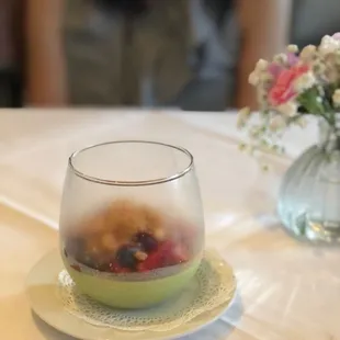 Pistachio panna cotta with red berries and almond crumbles