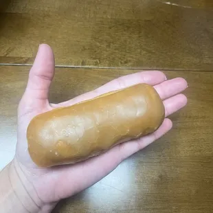 a hand holding a doughnut