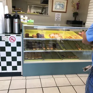 a man standing in front of a deli counter