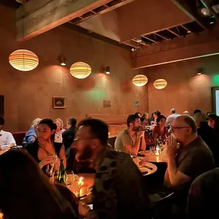 a group of people sitting at a table in a restaurant
