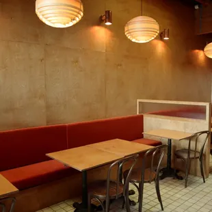 a dining area with red booths and wooden tables