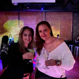 two women holding wine glasses