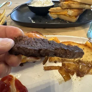 Semi-burned, hard, non-juicy, cardboard texture burger patty used for bacon caramelized onion cheese burger.