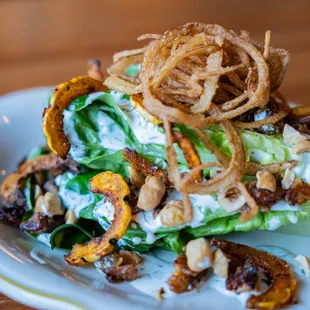 Veggie wedgie salad with fried onions, hazelnuts, and candied bacon