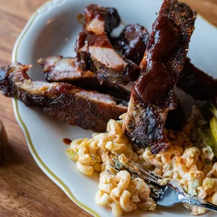 Applewood roasted pork ribs with a side of sriracha mac and cheese.