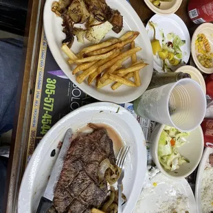 Rib eye steak with side of fries and potatos