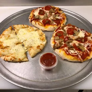 three pizzas on a metal tray