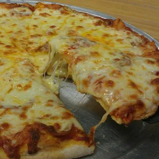 a cheese pizza with a slice taken out of it