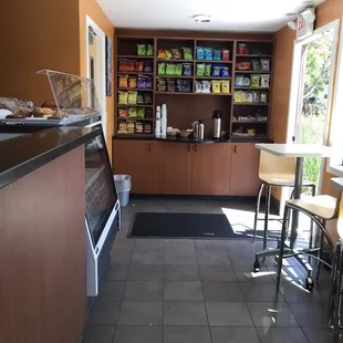 Wall of chips, snacks and coffee condiments.