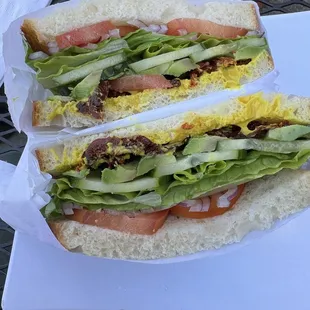 Avocado, cucumbers, sun dried tomatoes sandwich