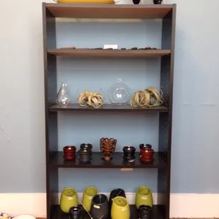 a shelf full of coffee cups