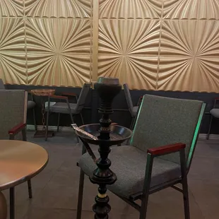 a hookah lounge with chairs and tables