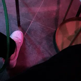 a person's feet in pink sneakers