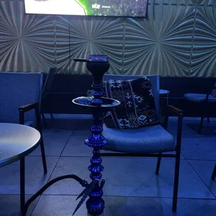 a hookah lounge area with chairs and tables