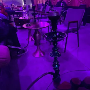 a hookah lounge with purple lighting