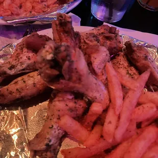 Lemon pepper wings with fries.