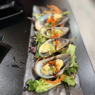 a row of mussels on a plate