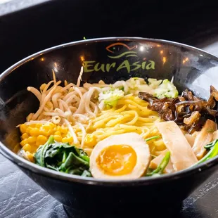 a bowl of noodles with an egg