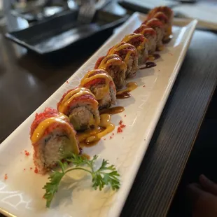 a long rectangular plate with sushi on it