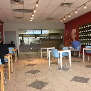 people sitting at tables in a restaurant