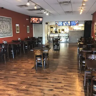 the interior of a restaurant with tables and chairs