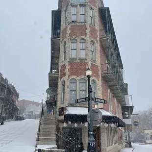 Eureka Charcuterie and the Flat Iron building in the snow.