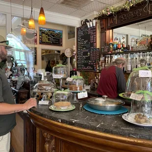 a man standing at a counter in a restaurant