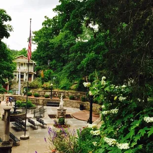 a view of a patio with benches and flowers