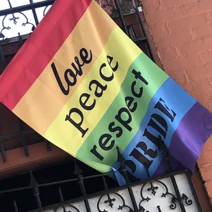 a rainbow flag that reads love peace respect trump