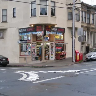 a street corner with cars parked in front of it
