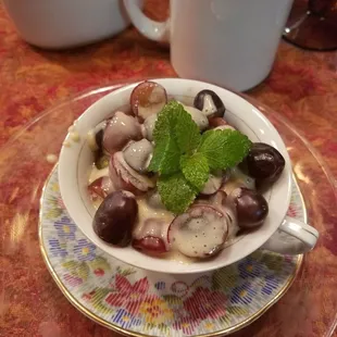 Breakfast morning 1, fruit starter - grapes in a sweet yogurt sauce (with brown sugar maybe?)