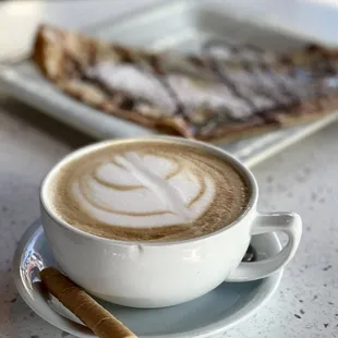 a cup of coffee and a slice of pizza