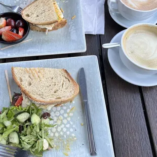 two plates of food and a cup of coffee